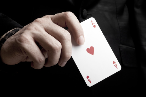 ace of hearts in a man's hand.