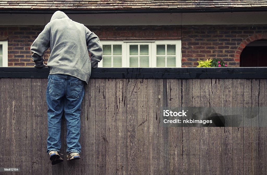 Мальчик в hoodie Нарушение границы на отдельной жилой недвижимости - Стоковые фото Нарушение границы роялти-фри
