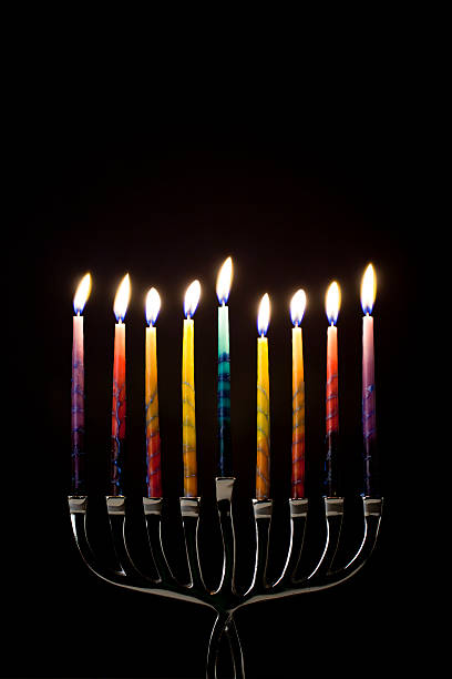 colorful menorah Colorful candles lit on a silver menorah. hanukkah candles stock pictures, royalty-free photos & images