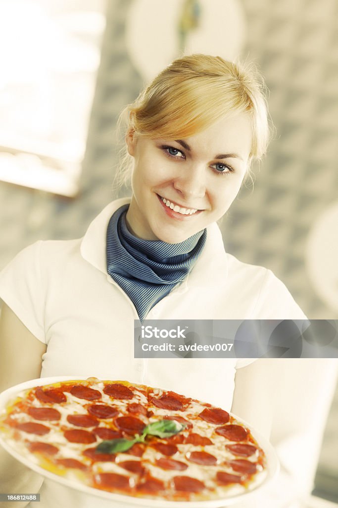 Waitress in a Restaurant Waitress holding a pizza. Adobe RGB Pizza Stock Photo