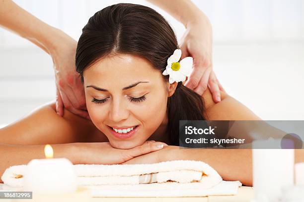 Beautiful Brunette Receiving A Back Massage Stock Photo - Download Image Now - Adult, Adults Only, Alternative Medicine