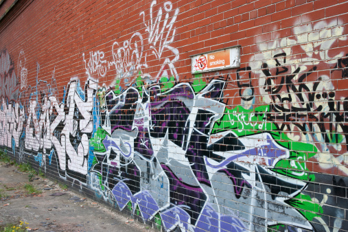 Grafitti covered wall at an angle