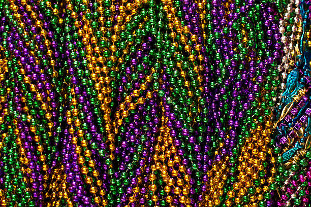 Close-up background of Mardi Gras beads Full frame image of Mardi Gras beads. bead photos stock pictures, royalty-free photos & images