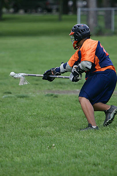 istock Young Male Lacrosse Player Balances Ball on Scoop 186814002