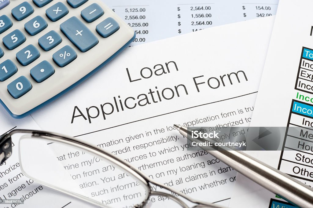 Loan Application Form with pen, calculator Close up of Loan Application Form with pen, calculator Financial Loan Stock Photo