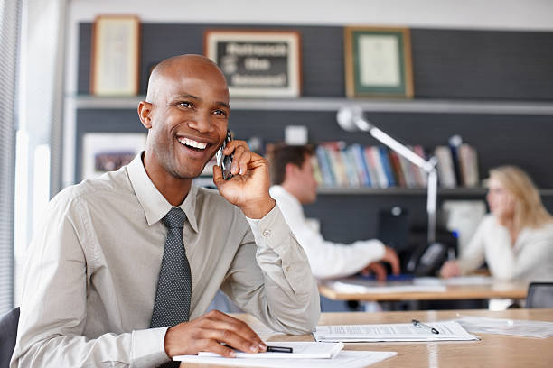 istock Cheerful businessman talking on the cellphone 186814478