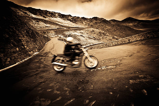istock Motorcycle Driving on a Mountain Road, Dramatic Sky, Roadtrip Travel 186814716