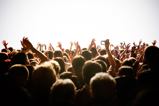 An Americana folk-rock band performing onstage in front of an audience at a live music venue.