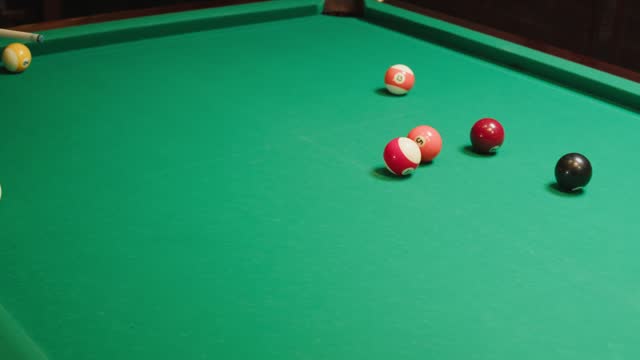 Playing American billiard poule close-up. Colorful balls on green billiards table .Billiard balls with numbers on a pool table. Billiards team sport.