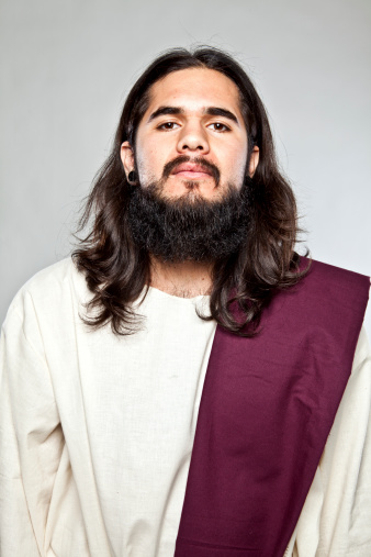 A young hispanic adult dressed as jesus.