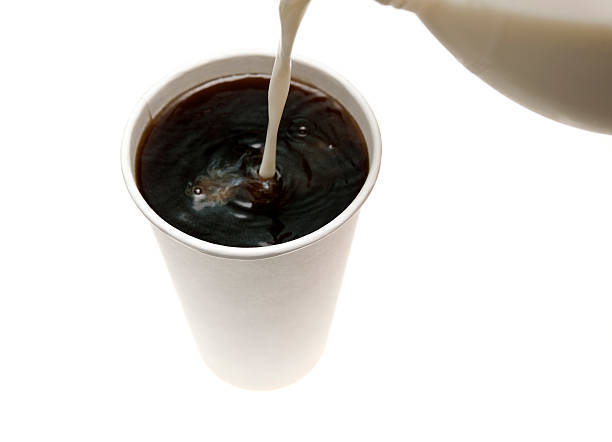 istock Milk pouring into takeout black coffee 186815149