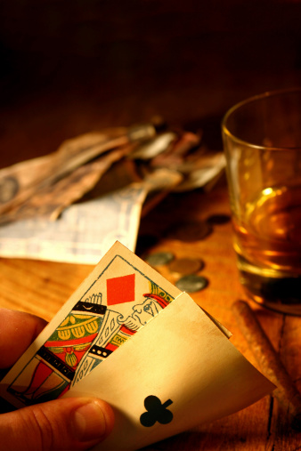 Vintage Ace of clubs and King of diamonds.  Whiskey and antique money in the background for that vintage look.  Shallow focus is on King.