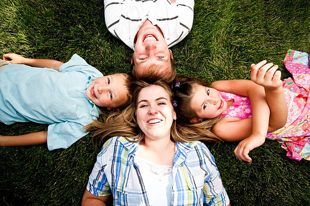 istock Children and Teens lying on Grass 186815461
