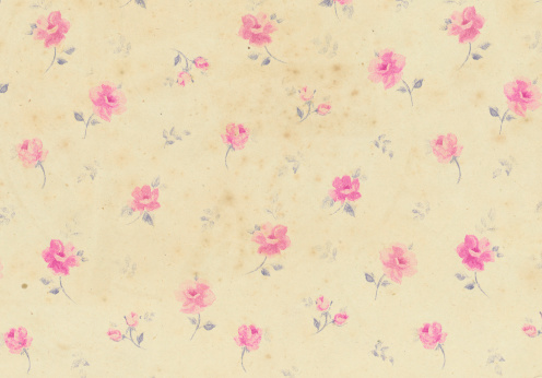 Old rose patterned wallpaper with stains
