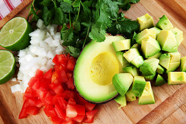Diced avocado, tomato, and onion on chopping board