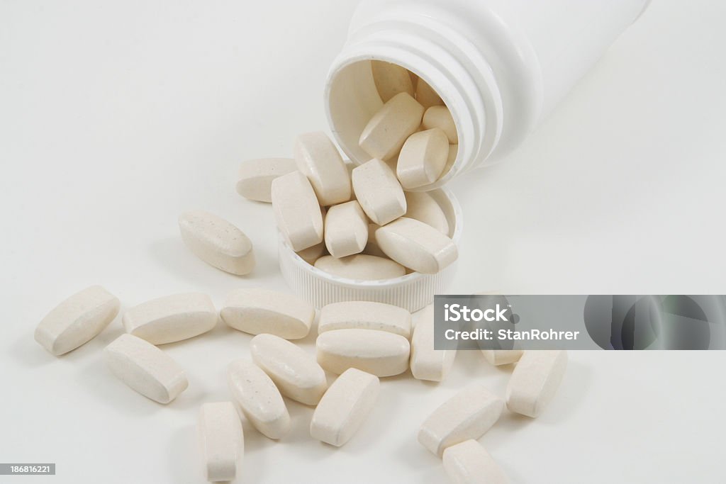 Caplets With White Bottle Caplets with white pill bottle. All in focus. Addiction Stock Photo