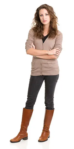 Photo of Young woman standing and looking at camera with arms crossed