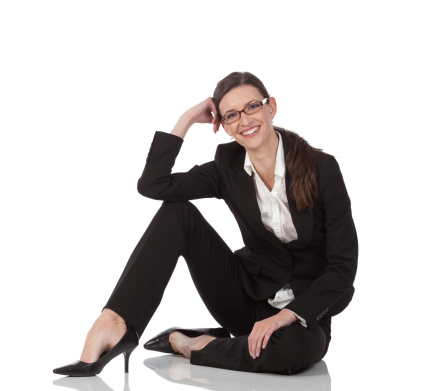 Businesswoman sitting on the floor and smiling