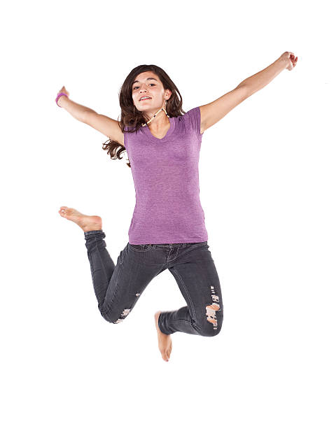 teenager-mädchen springen auf weißem hintergrund - arms outstretched teenage girls jumping flying stock-fotos und bilder