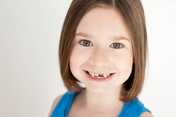 istock Close Up of Little Girl Smiling With Missing Tooth 186816916