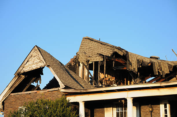 istock Home roof damaged by fire 186817197