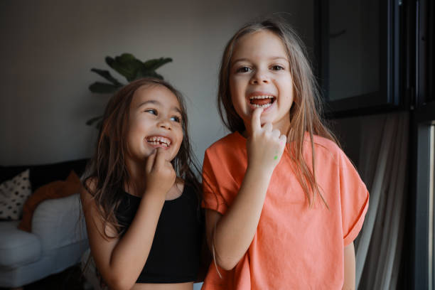 Girls Shows Off Missing Tooth Children smiles for the camera, showing off that he lost her baby tooth. baby teeth stock pictures, royalty-free photos & images