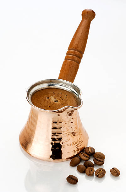 Ibrik with coffee and beans Ibrik with hot prepared turkish coffee and coffee beans on white background turkish coffee pot cezve stock pictures, royalty-free photos & images