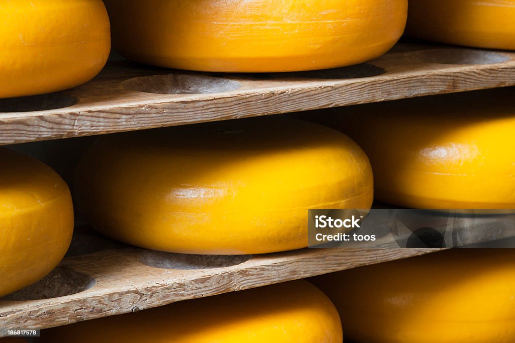 「ウィールズ」の直下のチーズ、木製の棚(XL - ゴーダチーズのロイヤリティフリーストックフォト