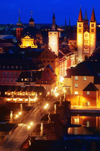 Elevated nightview on the city of Würzburg with the illuminated Cathedral (Kiliansdom), City hall (Rathaus) and the Old Mainbridge (Alte Mainbrücke).