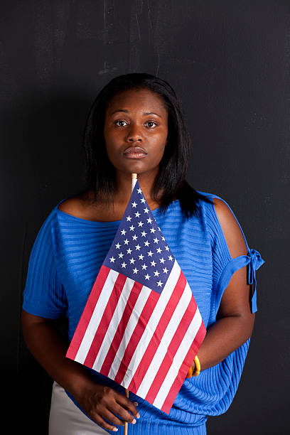 istock black female holds American flag 186818594