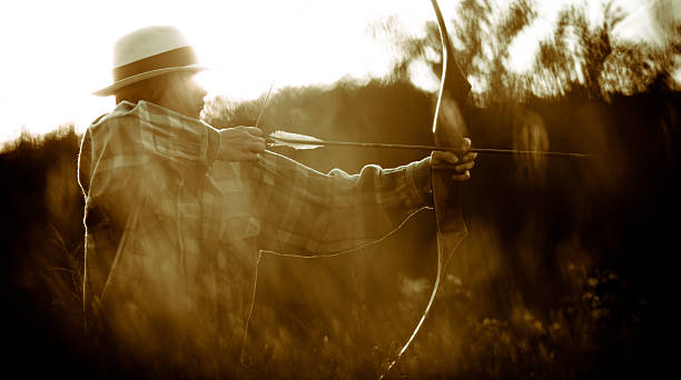 istock Young man firing bow and arrow 186819508