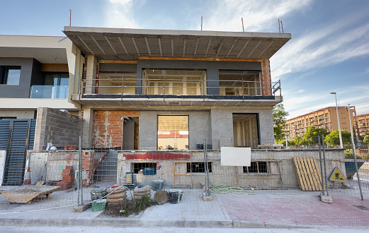 Townhouse under construction. Villa and Prefab house under construction. Construction of modern house and Townhouses in Spain. Building Home renovation. Prefabricated build on Construction site.