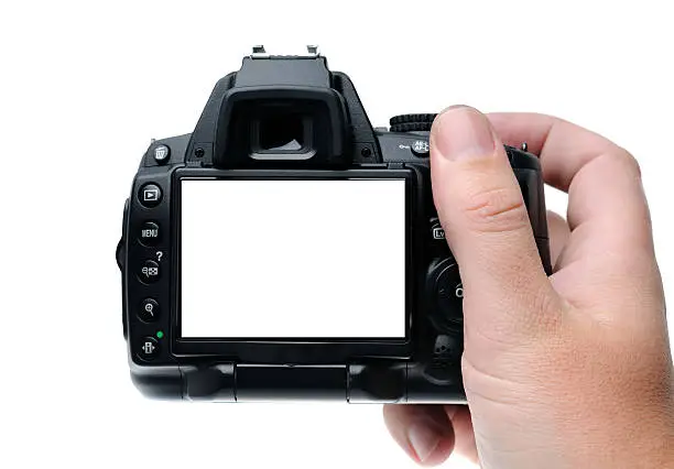 Hand holding a digital camera. LCD screen on the camera is blank.