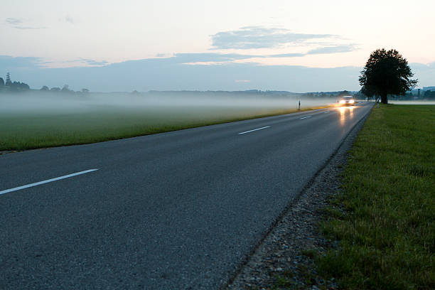 istock Car on foggy road at dawn 186820187