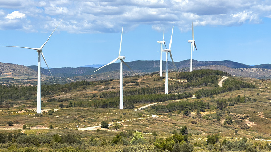 Wind turbine in mountains landscape. Eolic park windpower. Wind farm, New Wind green energy. Wind turbines alternative energy. Windmill power clean electricity generation. Spain Windfarm in Castellon