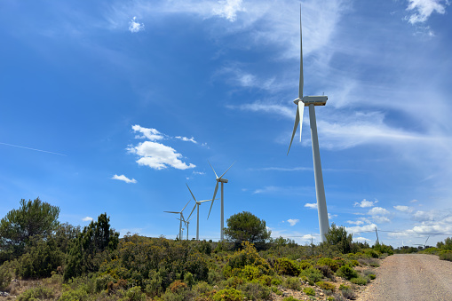 Wind turbine in mountains. Eolic park windpower. Wind farm or New Wind green energy. Wind turbines alternative energy. Windmill power clean electricity generation in Viver, Castellón, Caudiel, Spain