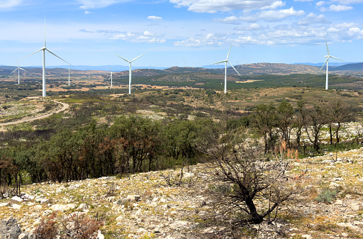 Wind turbine in mountains landscape. Eolic park windpower. Wind farm, New Wind green energy. Wind turbines alternative energy. Windmill power clean electricity generation. Spain Windfarm in Castellon