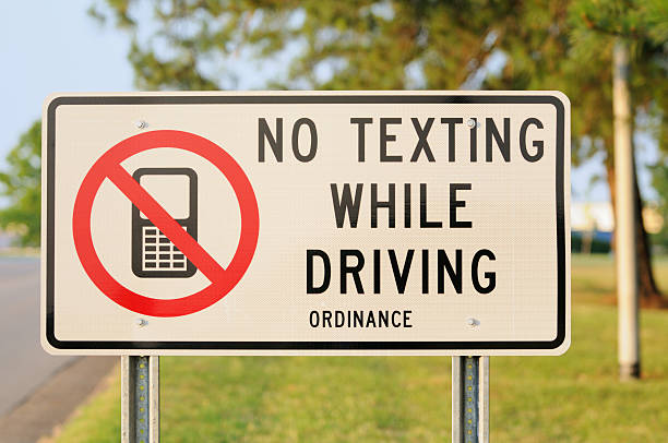 istock Close up of no texting while driving sign 186820411