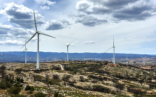 Wind turbine in mountains landscape. Eolic park windpower. Wind farm, New Wind green energy. Wind turbines alternative energy. Windmill power clean electricity generation. Spain Windfarm in Castellon
