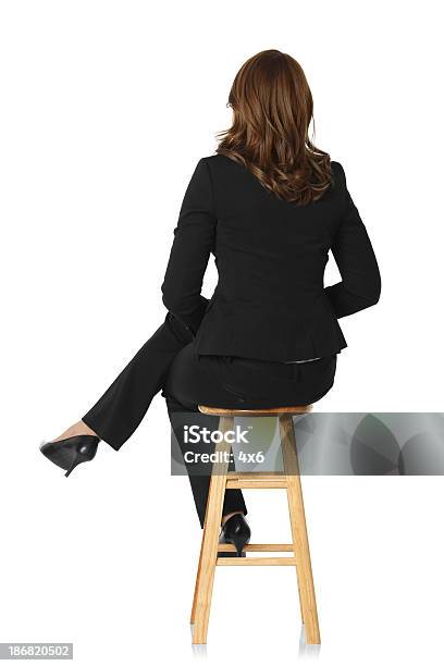 Rear View Of A Businesswoman Sitting On Stool Stock Photo - Download Image Now - Rear View, Sitting, People