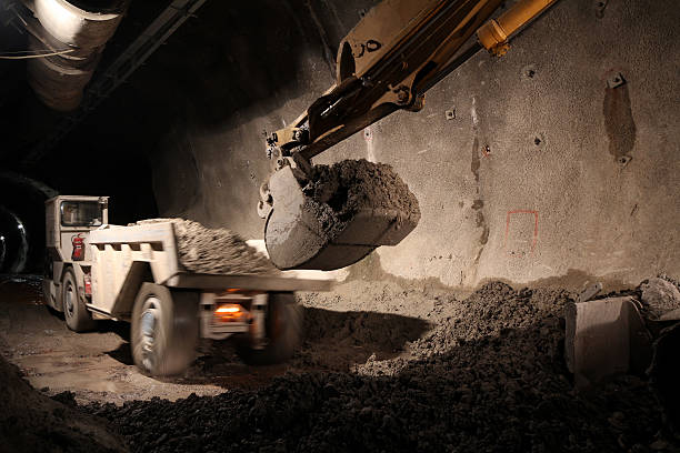 istock Dump truck being loaded with dirt at night 186820504