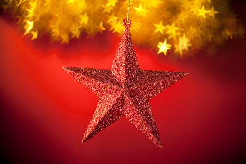 Christmas red star with star shape light background.