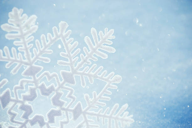 istock White Winter Snowflake Close-Up Sparkling in Sunlight 186821421