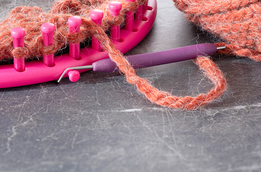 Knitting loom with a soft, fuzzy, chunky yarn.