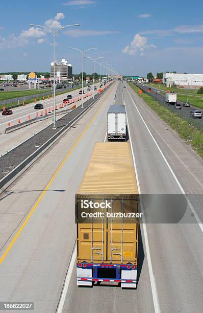 Two Trucks On The Middle Track Of The Highway Stock Photo - Download Image Now - Awe, Business Travel, Capital Cities