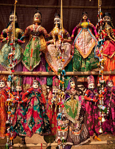 Indian Folk Dolls "Indian puppet dolls in the outdoor market in Agra.These sites are common all over India, where tourists stop by to purchase mementos. These figurines are home made crafts, not copyright pieces of art work." doll puppet indian culture small stock pictures, royalty-free photos & images