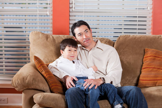 istock Father and son sitting on couch 186823120