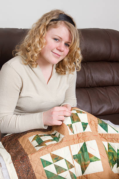 istock Young Woman Quilting 186823823