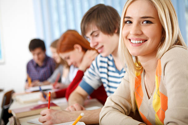 istock Beautiful female college student smiling in the classroom 186824155