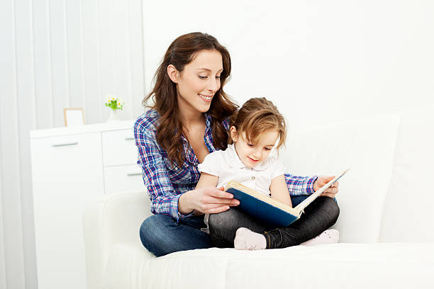 istock Mother and daughter reading book 186824163